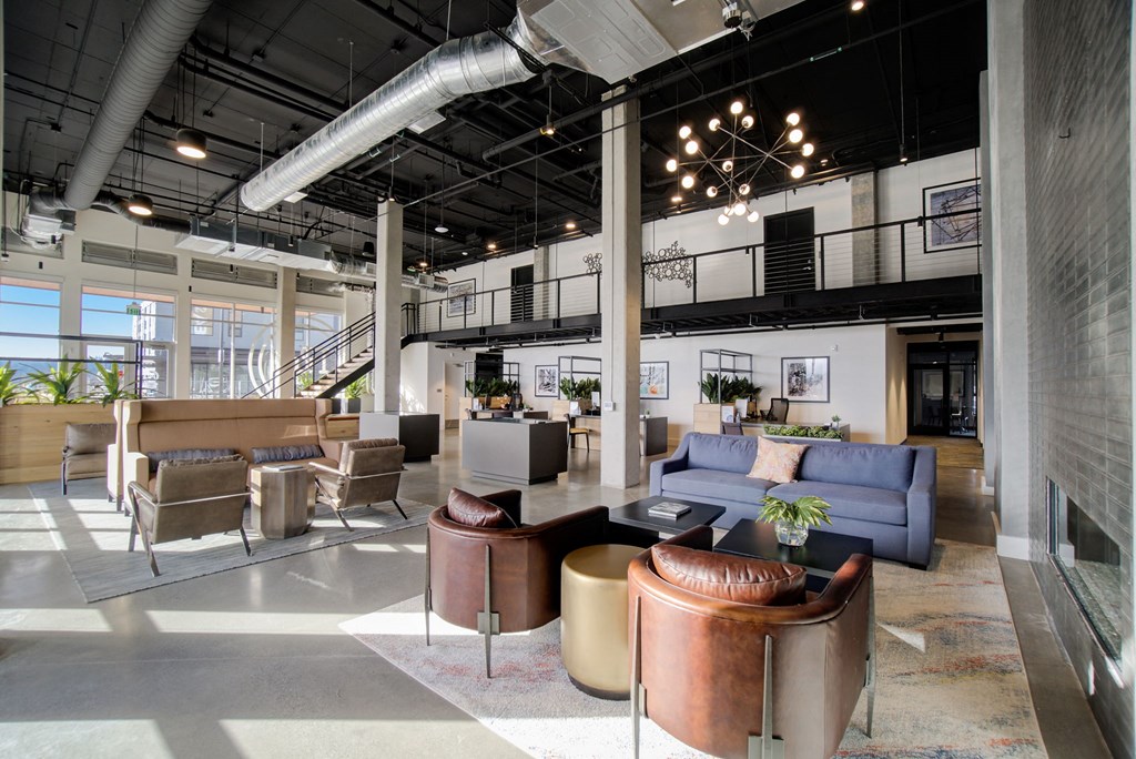 the lobby of a building with couches and chairs