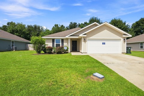 A house with a garage and a driveway in front.