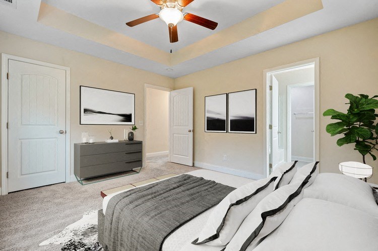 Omnia at Richmond Hill Townhomes in Georgia photo of a bedroom with a bed and a ceiling fan.