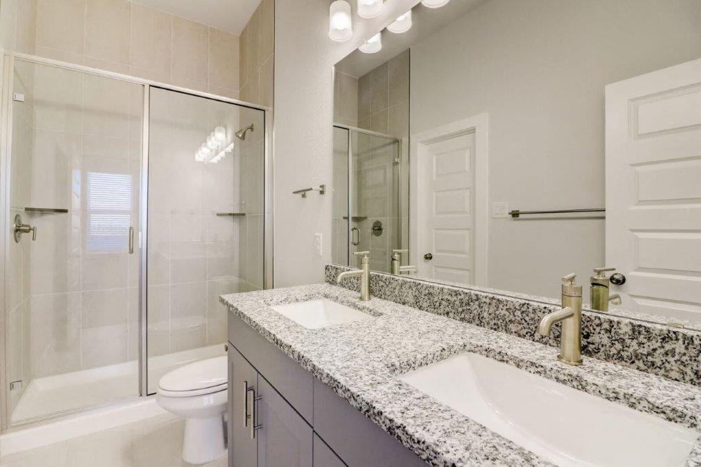 a bathroom with a sink and a toilet and a shower