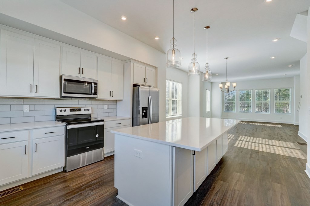Henley Avondale kitchen in Avondale Estates, GA, with white cabinetry and a spacious central island.