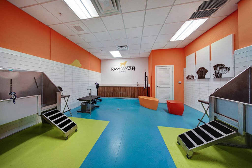 a fitness room with weights and a yoga instructor in the back