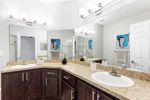 Atlanta, GA Apartments – One K Apartments – bathroom with two sinks and a mirror