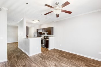 One K Apartments in Atlanta Georgia photo of a living room and kitchen area with a ceiling fan - Photo Gallery 6