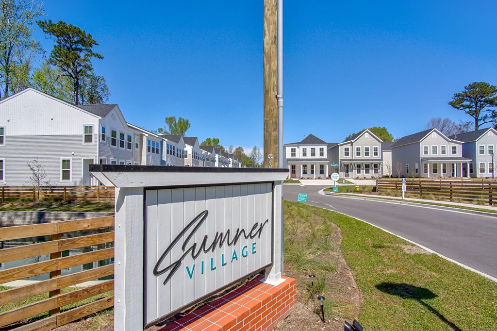Townhomes North Charleston, SC - Sumner Village - Property Sign at the Entrance to the Driveway Leading to Rows of Homes.
