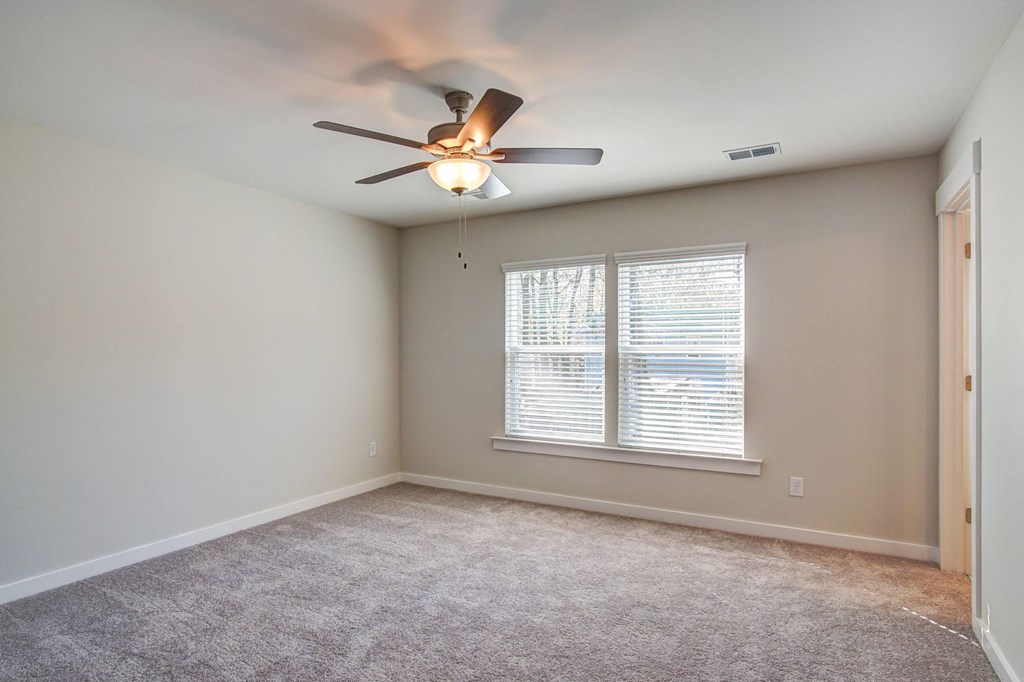 3-BR Homes In North Charleston, SC - Sumner Village - Spacious Bedroom With Carpet Flooring, Ceiling Fan, Large Window, And Access To The Bathroom