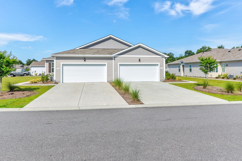 a house with a white garage door in front of a driveway