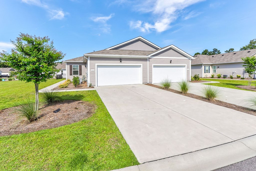 a house with a driveway and a garage door in front of it
