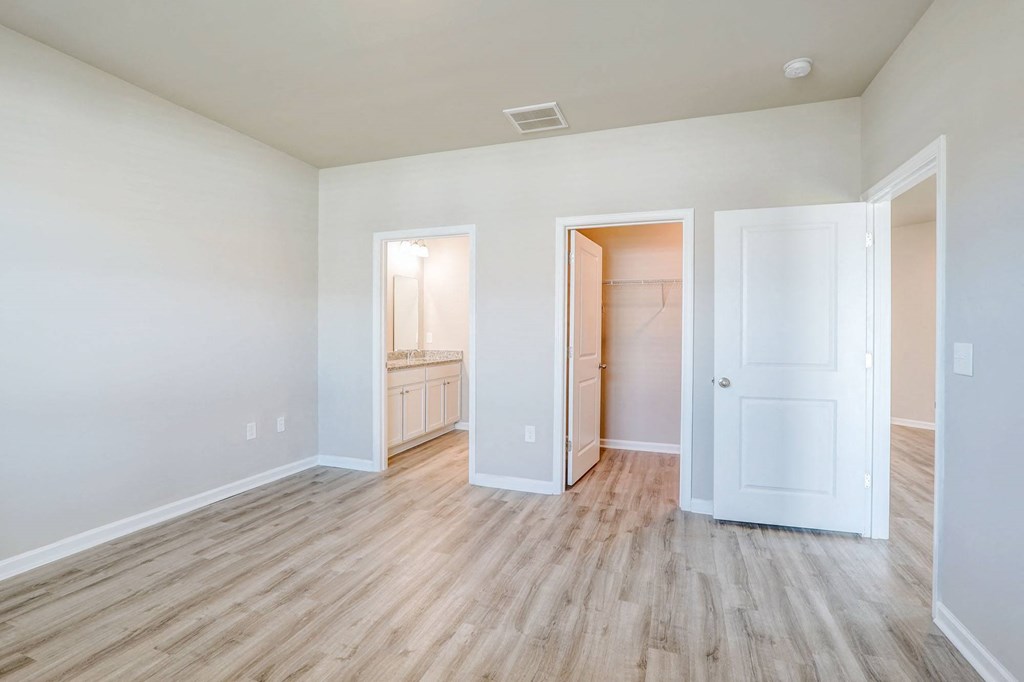 a renovated living room with wood flooring and white walls