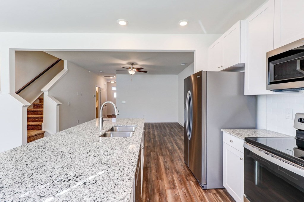 a kitchen with granite counter tops and stainless steel appliances