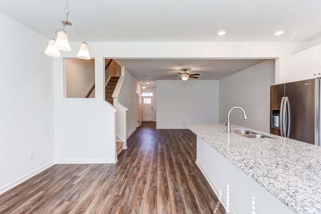 an empty kitchen with a counter top and a sink