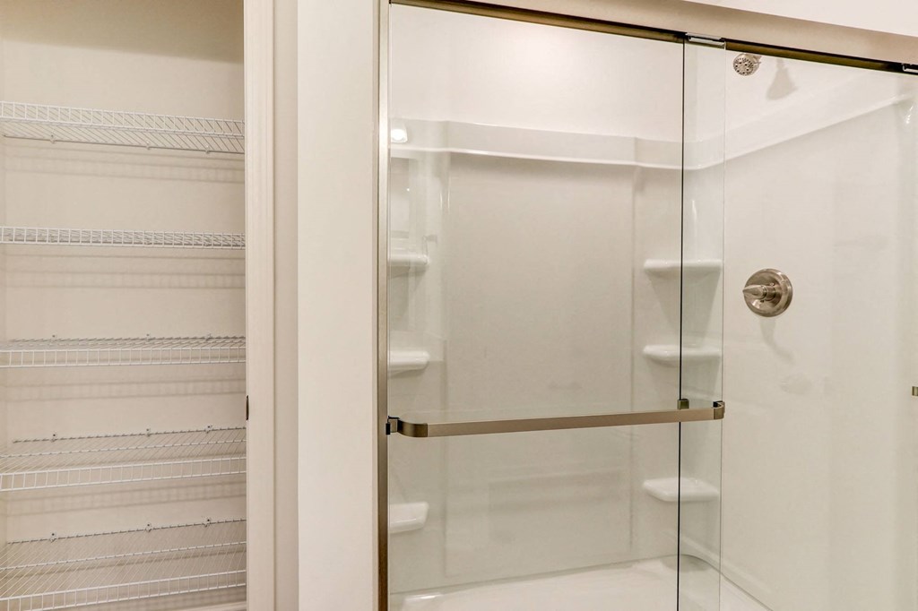 a shower with a glass door in a bathroom
