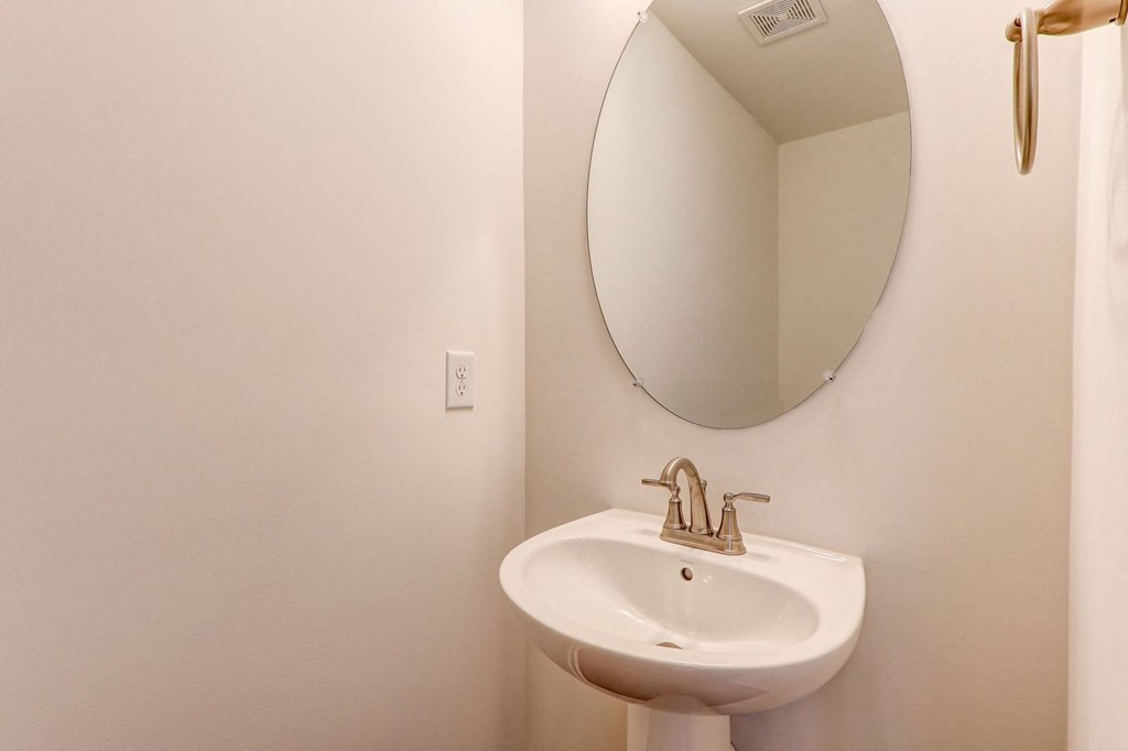 a small bathroom with a sink and a mirror