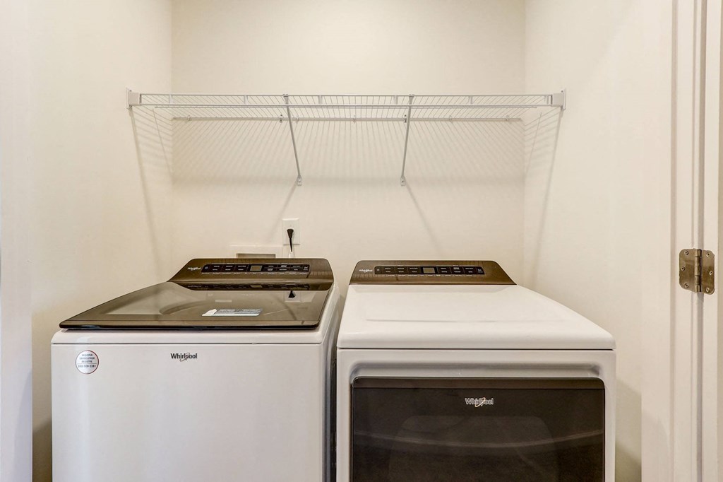 a laundry room with two washes and a dryer