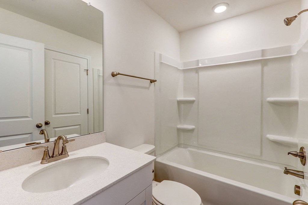 a bathroom with a sink and a tub and a mirror