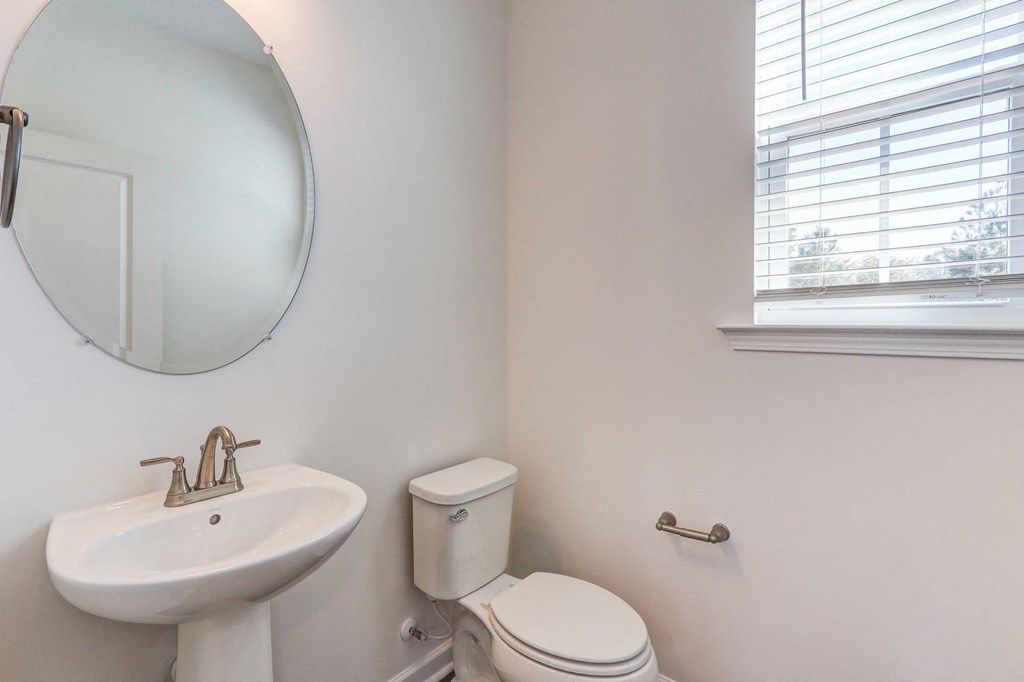 a bathroom with a sink and a toilet and a mirror
