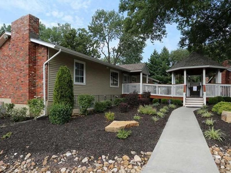 a house with a porch and a gazebo