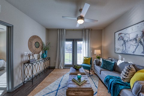 a living room with a couch and a ceiling fan