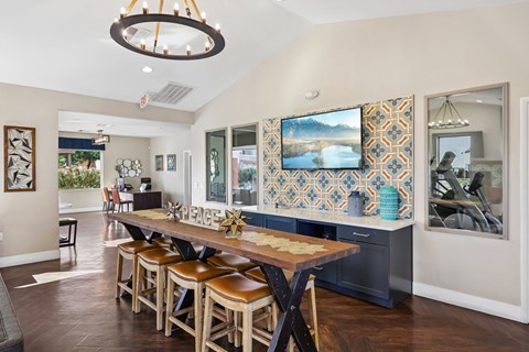 A modern dining room with a wooden table and chairs.