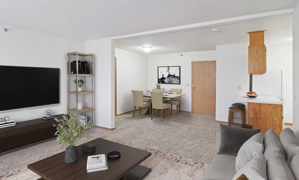 A living room with a grey couch and a wooden coffee table.