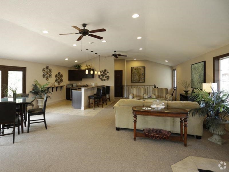 a living room filled with furniture and a ceiling fan