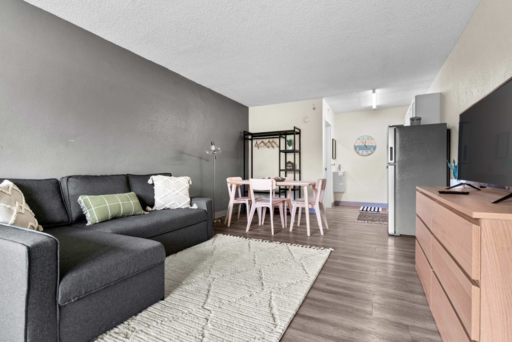 a living room and dining room with a couch and a table