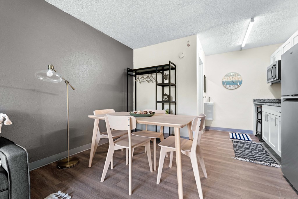 a dining room with a table and chairs next to a kitchen