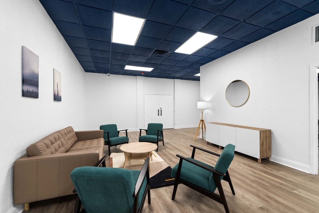 a living room with couches chairs and a table