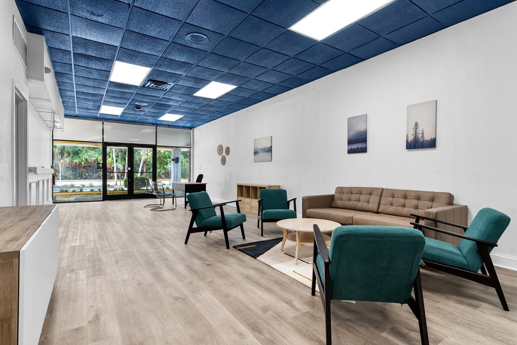 a living room with a couch and chairs and a table