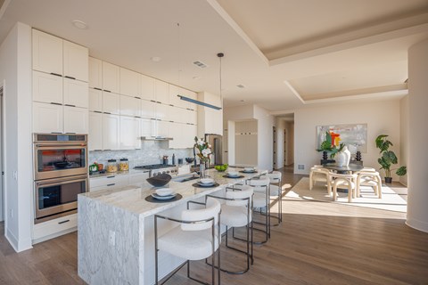 A modern kitchen with a dining table and chairs.