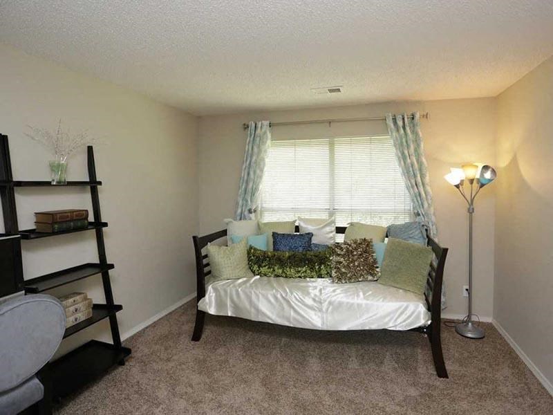 a bedroom with a bed and a bookshelf