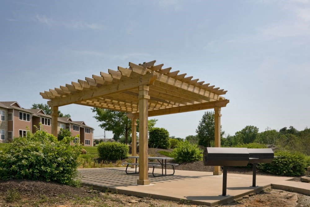 a picnic shelter with a grill in a park