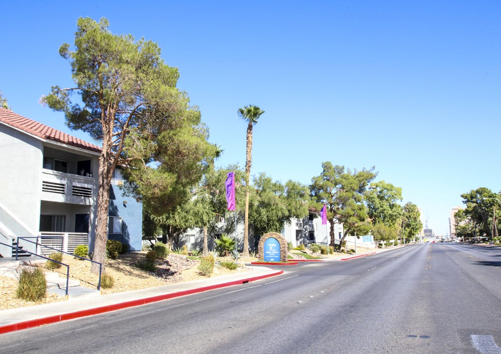 a street with houses and trees on the side of a road