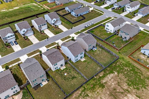 A bird's eye view of a residential area with houses and roads.