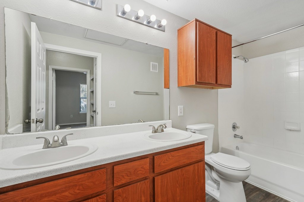 A bathroom with a white sink and a white toilet.