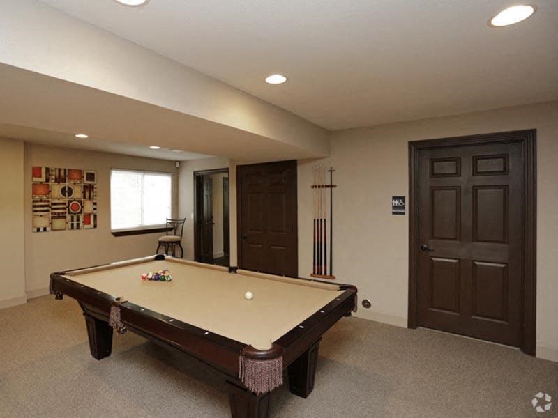 a pool table in a room with two doors