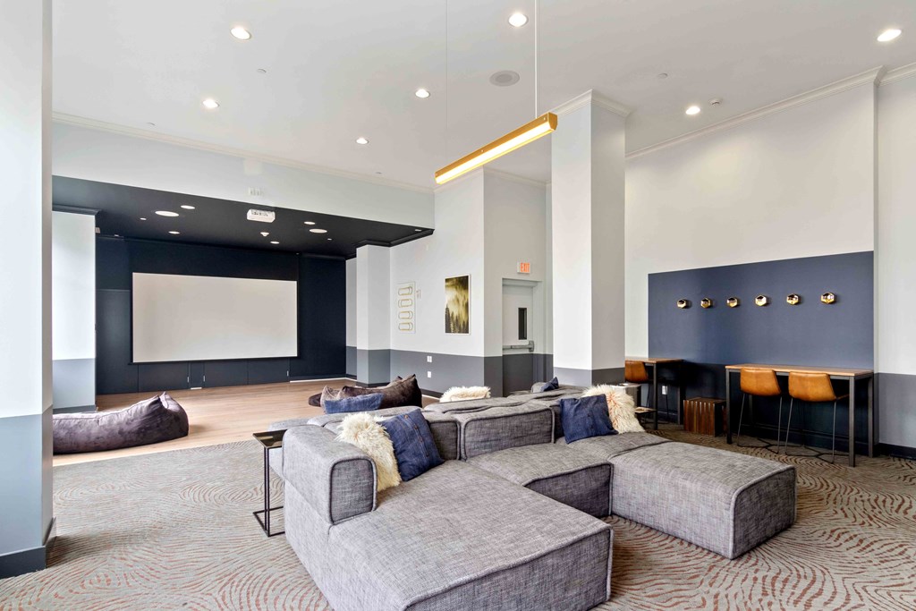 resident lounge with movie screen and seating