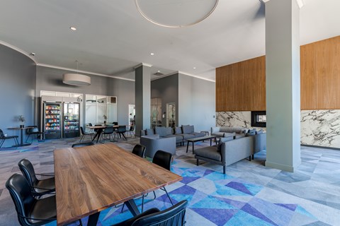 A modern dining room with a wooden table and chairs.