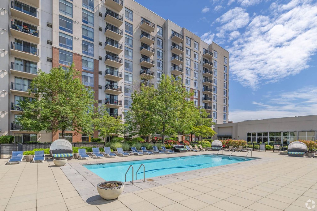 a swimming pool in front of an apartment building