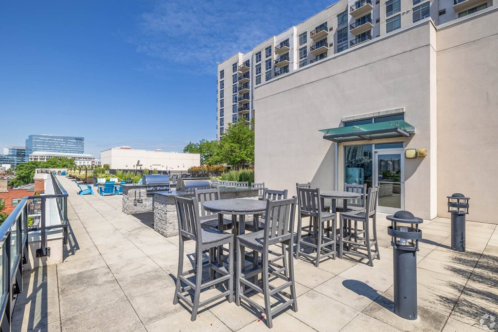 a patio with tables and chairs outside of a building