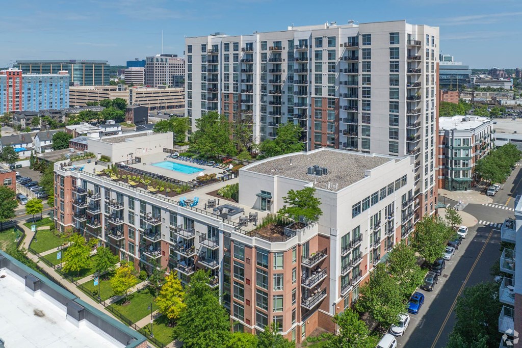 an aerial view of a building with a pool in front of it