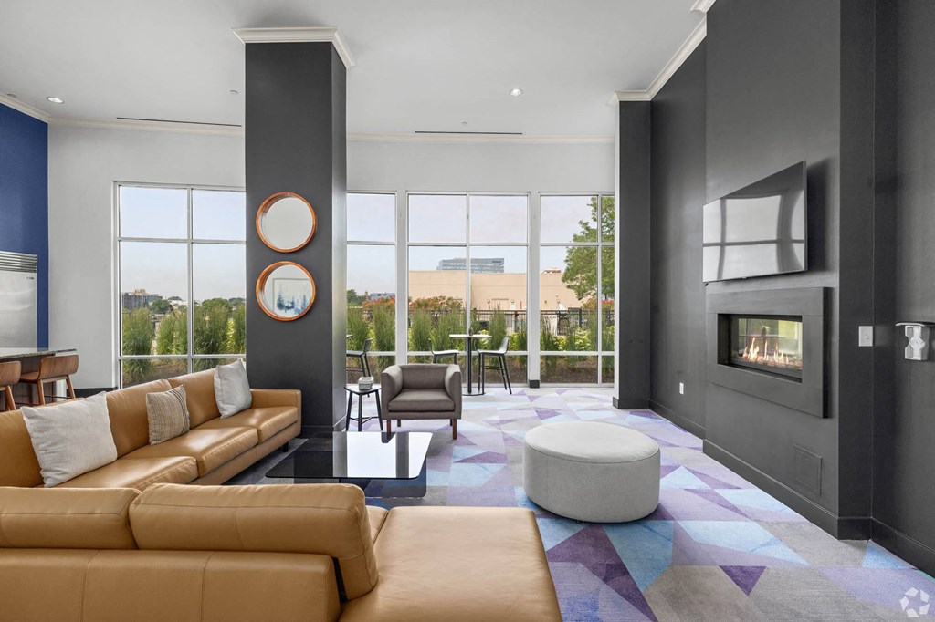 a living room with leather furniture and a fireplace