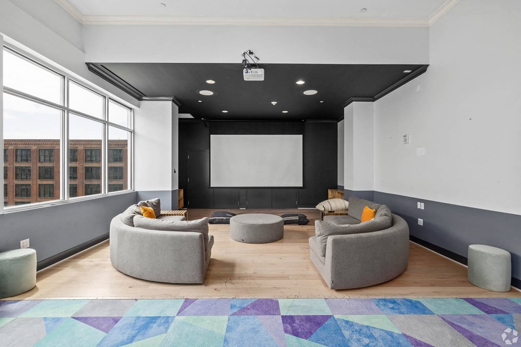 a large living room with couches and a projector screen