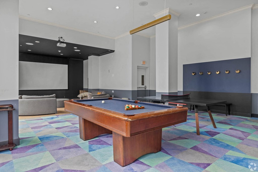 a game room with a pool table and a ping pong table