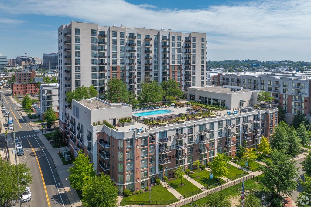an aerial view of a building with a pool in the middle