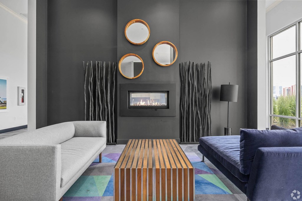 a living room with couches a coffee table and a fireplace