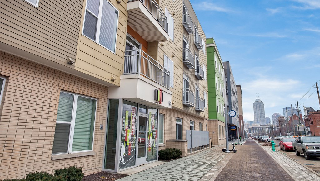 a view of a building on a city street with a city in the background