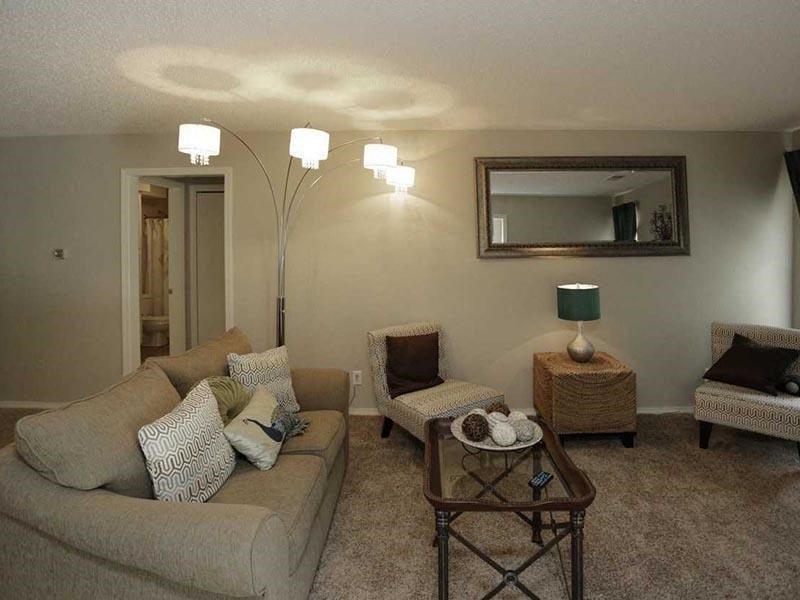 a living room filled with furniture and a mirror