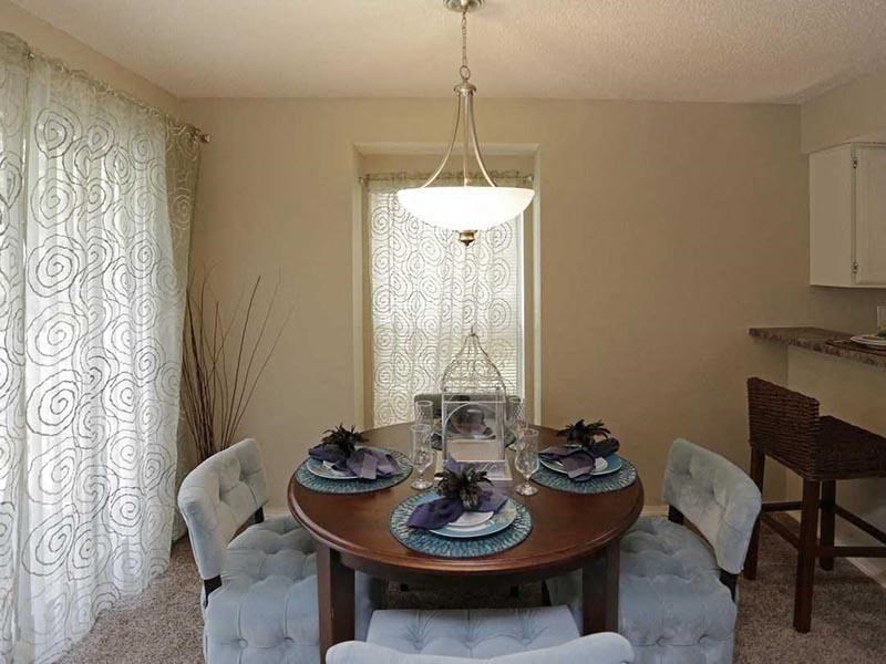a dining room with a table and chairs and a chandelier
