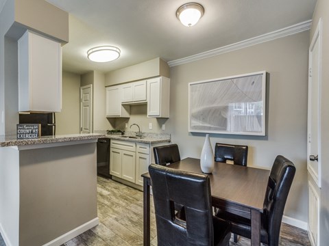a kitchen and dining room with a table and chairs
